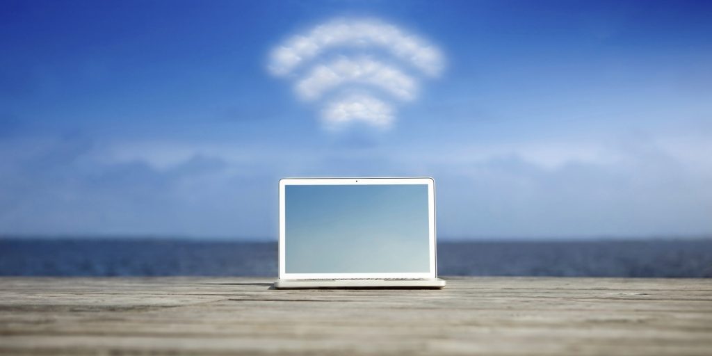 Laptop with wifi symbol at the coast